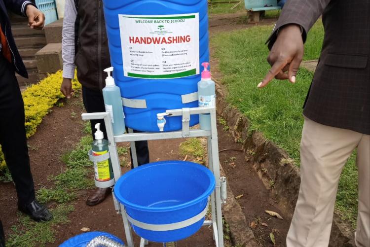 Nupsa patron Dr. Ndwiga  receives the handwash station